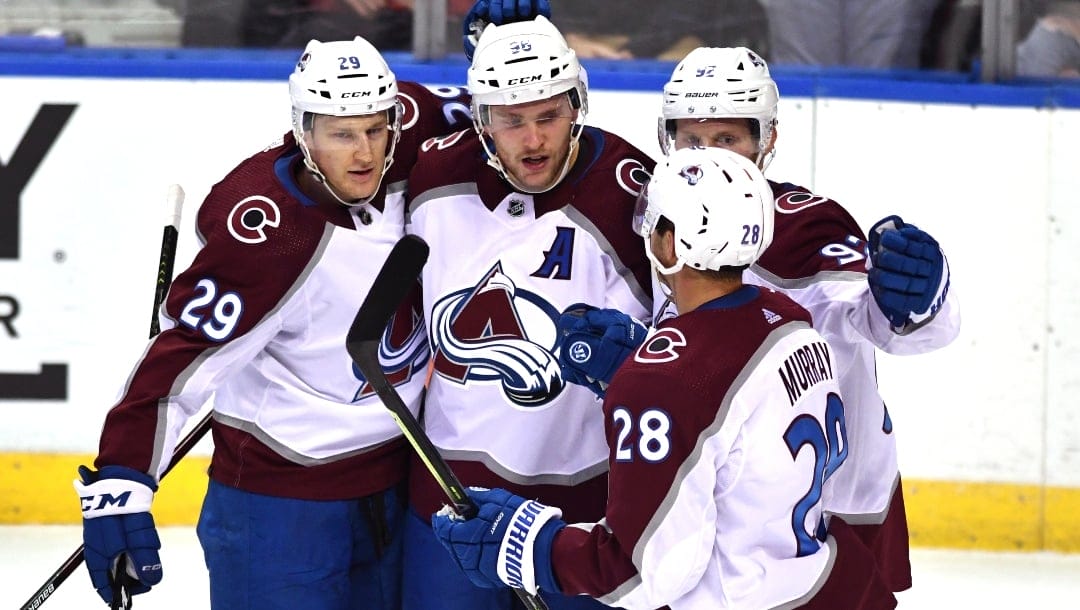 Colorado Avalanche right wing Mikko Rantanen (96) celebrates a goal against the Florida Panthers with Nathan MacKinnon (29), Gabriel Landeskog (92) and Ryan Murray (28) during the first period of an NHL hockey game Tuesday, Oct. 21, 2021, in Sunrise, Fla.
