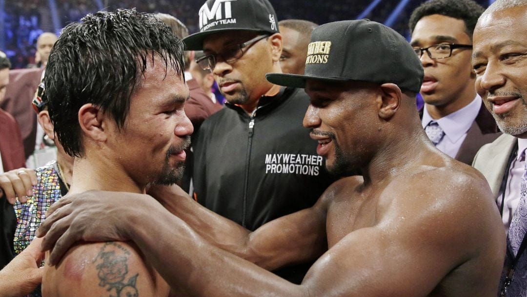 This May 2, 2015 file photo shows Manny Pacquiao from the Philippines, left, and Floyd Mayweather Jr., embracing in the ring.