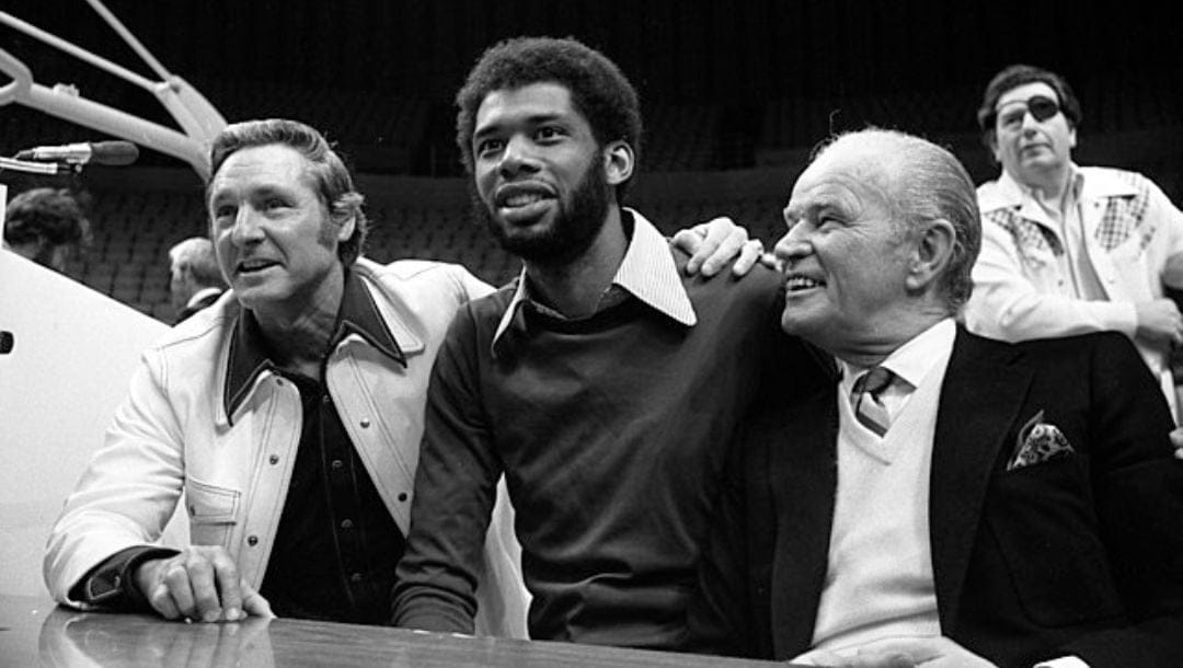 Bill Sharman, Kareem Abdul-Jabbar and Jack Kent Cooke at press conference announcing Lakers' signing Kareem in Los Angeles.