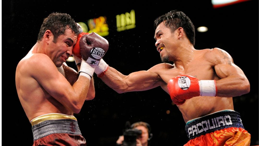 WBC lightweight champion Manny Pacquiao, right, connects with Oscar De La Hoya during the sixth round of their welterweight boxing match.