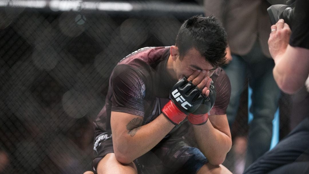 In this photo made available Sunday, June 21, 2015, Finland's Makwan Amirkhani cries after wining against Mexico's Masio Fullenduring.