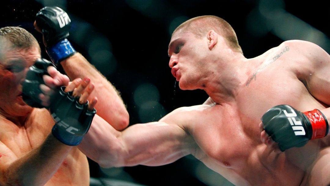 Todd Duffee, right, trades punches with Mike Russow during their UFC heavyweight mixed martial art match Saturday, May 29, 2010.