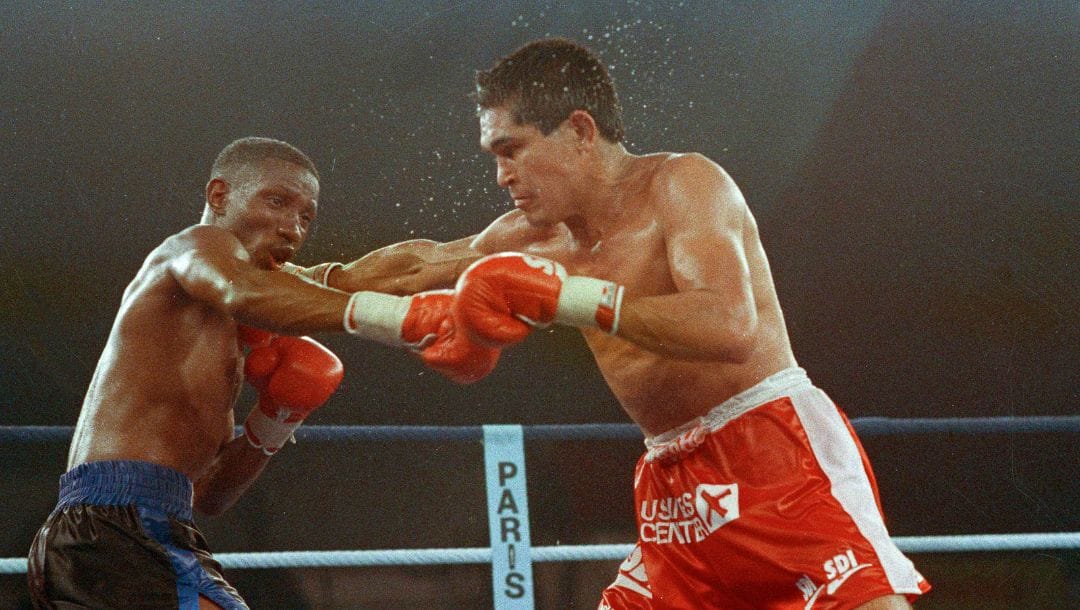 Jose Luis Ramirez of Mexico, right, hits American Pernell Whitaker, left, during their lightweight boxing match in Paris.