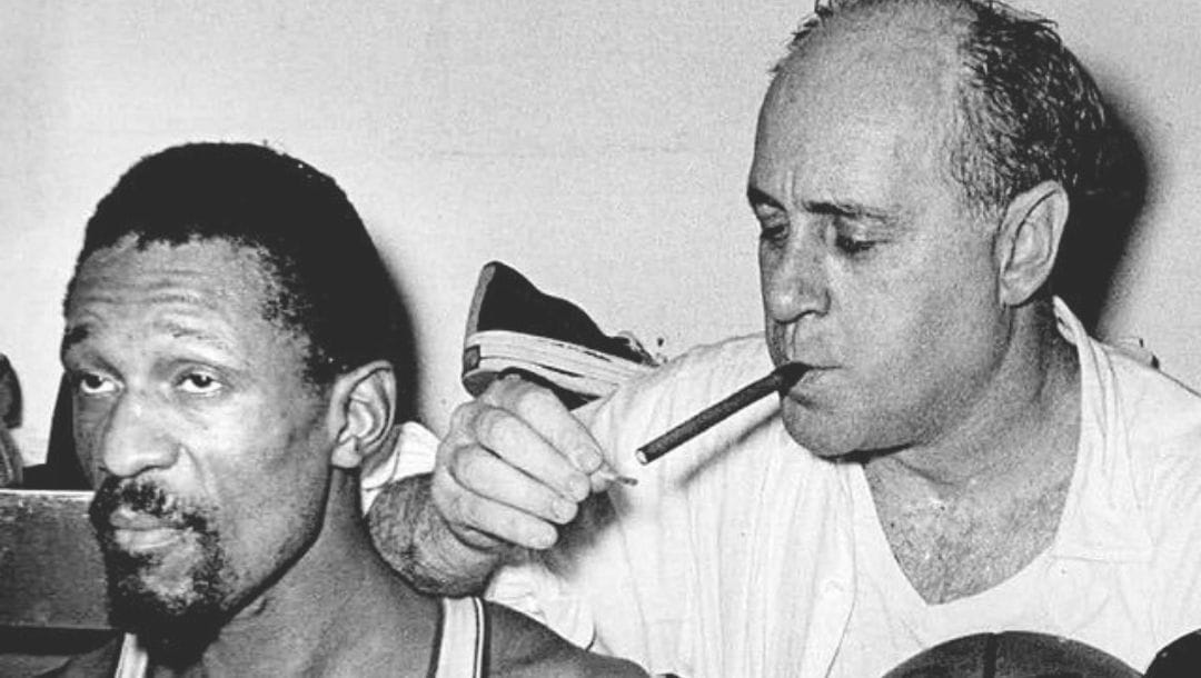 Boston Celtics center Bill Russell next to head coach Red Auerbach after winning the 1966 NBA Finals.