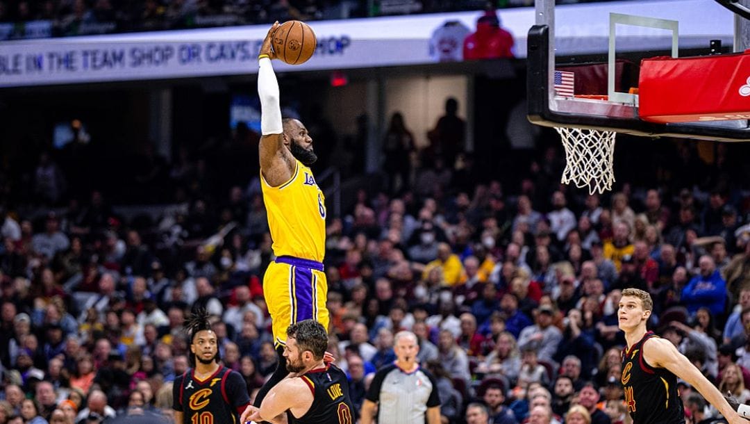 LeBron James dunks over Kevin Love in an NBA game in March 2022.