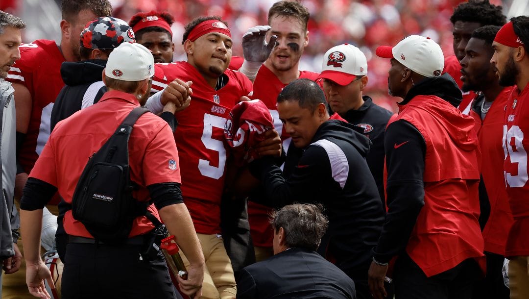 San Francisco 49ers quarterback Trey Lance (5) is helped onto a cart during the first half of an NFL football game against the Seattle Seahawks in Santa Clara, Calif., Sunday, Sept. 18, 2022. (AP Photo/Josie Lepe)