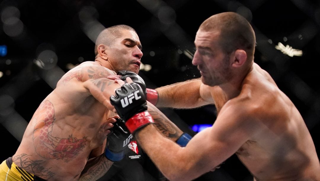 Alex Pereira, left, fights Sean Strickland in a middleweight bout during the UFC 276 mixed martial arts event Saturday, July 2, 2022.