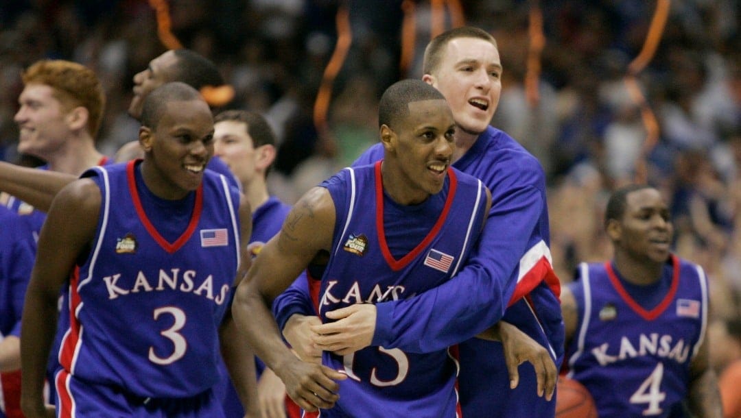 FILE - In this April 7, 2008, file photo, Kansas players Russell Robinson (3), Mario Chalmers (15) Brady Morningstar, rear, and Sherron Collins, right, celebrate their 75-68 victory over Memphis in the NCAA college basketball Final Four in San Antonio. (AP Photo/Eric Gay, File)
