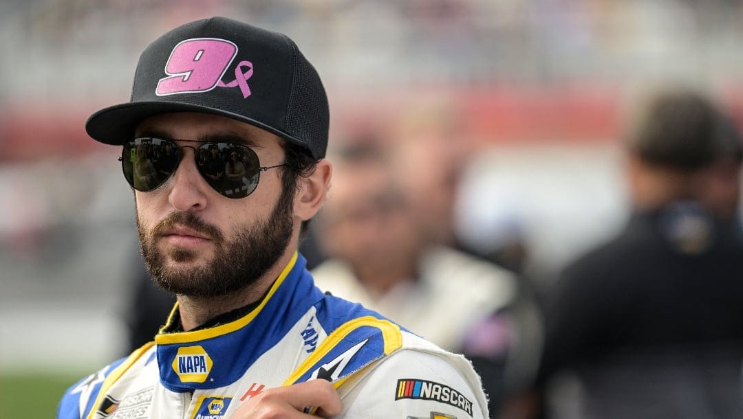 Chase Elliott (9) looks on prior to a NASCAR Cup Series auto race at Charlotte Motor Speedway, Sunday, Oct. 9, 2022, in Concord, N.C. (AP Photo/Matt Kelley)
