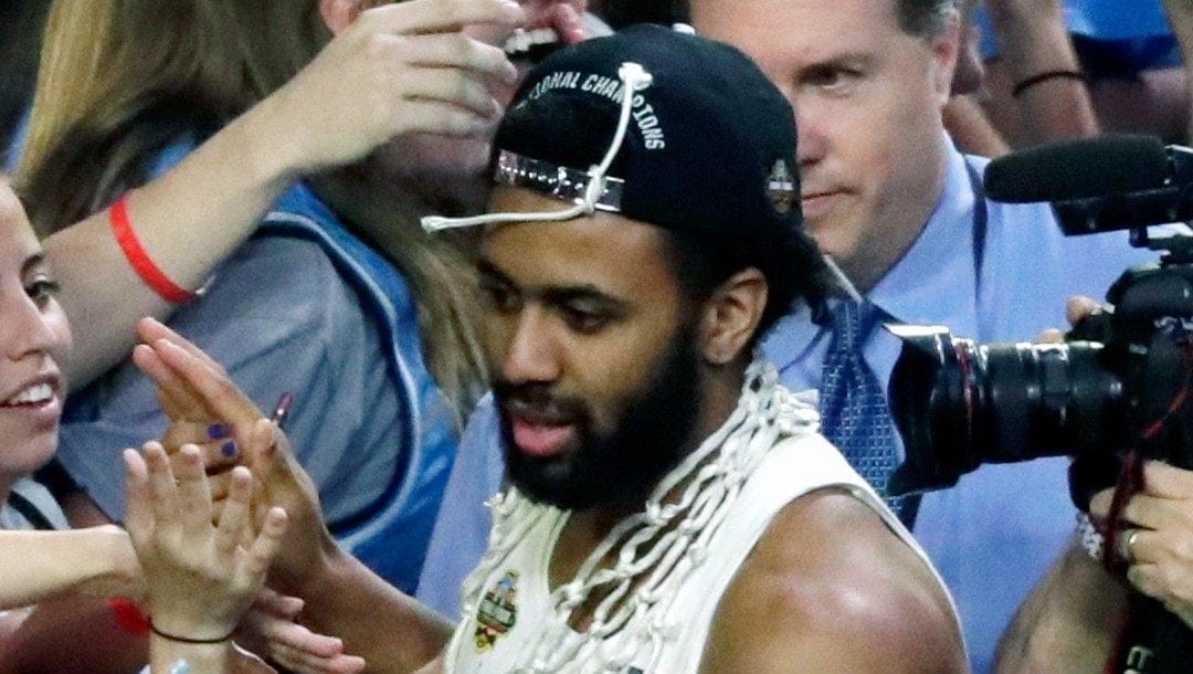 In this April 3, 2017, file photo, North Carolina guard Joel Berry II celebrates with fans after the championship game against Gonzaga at the Final Four NCAA college basketball tournament in Glendale, Ariz. North Carolina defeated Gonzaga 71-65. Berry was named MVP.