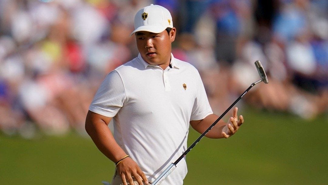 Tom Kim, of South Korea, reacts to a missed putt on the 15th green during their fourball match at the Presidents Cup golf tournament at the Quail Hollow Club, Saturday, Sept. 24, 2022, in Charlotte, N.C.