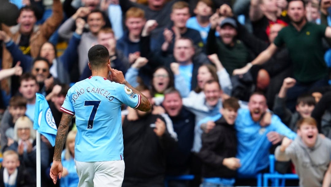 Manchester City's Joao Cancelo celebrates after scoring the opening goal during the English Premier League soccer match between Manchester City and Southampton at Etihad stadium in Manchester, England, Saturday, Oct. 8, 2022.