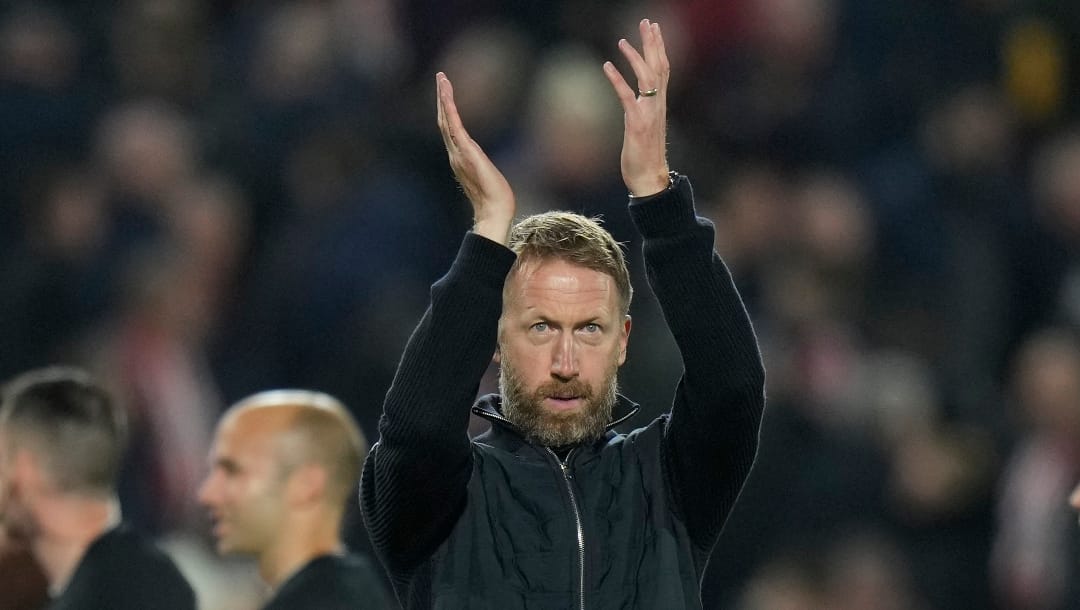 Chelsea's head coach Graham Potter applauds fans at the end of the English Premier League soccer match between Brentford and Chelsea, at the Gtech Community stadium, in London, England, Wednesday, Oct. 19, 2022.