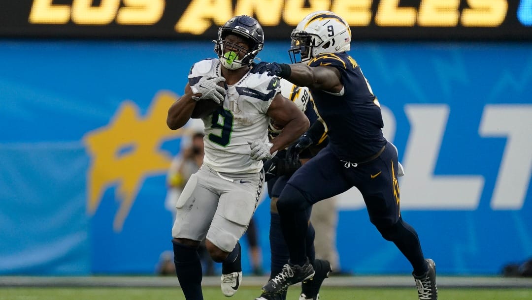 Seattle Seahawks running back Kenneth Walker III (9) runs to the end zone for a touchdown while defended by Los Angeles Chargers linebacker Kenneth Murray Jr. (9) during the second half of an NFL football game Sunday, Oct. 23, 2022, in Inglewood, Calif. (AP Photo/Mark J. Terrill)