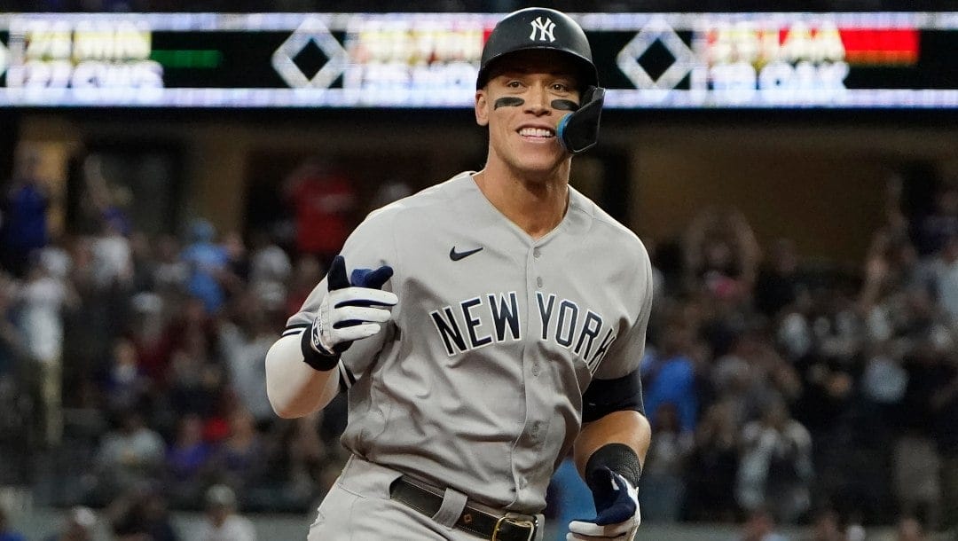 New York Yankees' Aaron Judge gestures as he rounds the bases after hitting a solo home run, his 62nd of the season, during the first inning in the second baseball game of a doubleheader against the Texas Rangers in Arlington, Texas, Tuesday, Oct. 4, 2022. With the home run, Judge set the AL record for home runs in a season, passing Roger Maris.