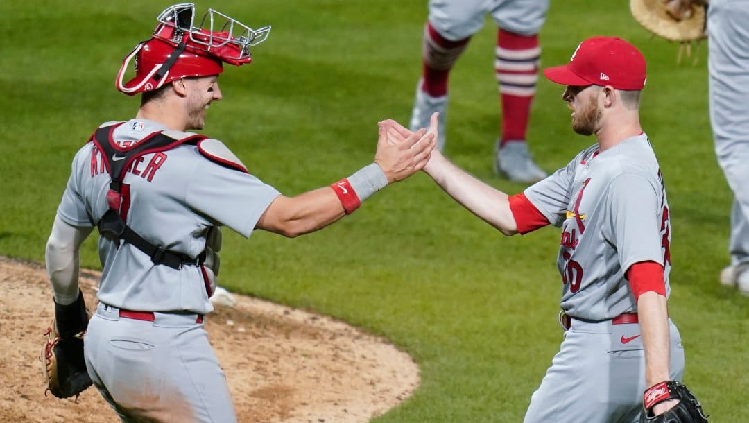 St. Louis Cardinals catcher Andrew Knizner, left, greets relief pitcher Chris Stratton after the team's 8-7 win in 10 innings in a baseball against the Pittsburgh Pirates on Tuesday, Oct. 4, 2022, in Pittsburgh.