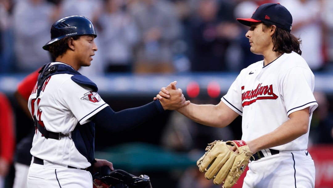 Cleveland Guardians catcher Bo Naylor, left, and relief pitcher Eli Morgan celebrate the team's 9-2 win against the Kansas City Royals in a baseball game Wednesday, Oct. 5, 2022, in Cleveland.