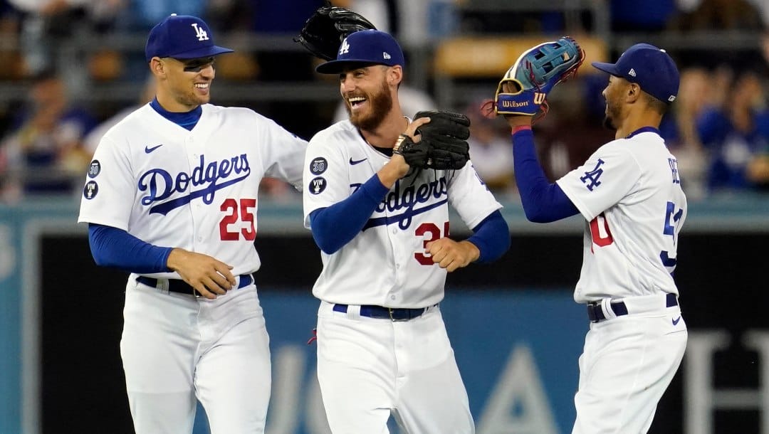 Los Angeles Dodgers' Trayce Thompson (25) Cody Bellinger, center, and Mookie Betts celebrate a 6-4 win over the Colorado Rockies during a baseball game Saturday, Oct. 1, 2022, in Los Angeles.