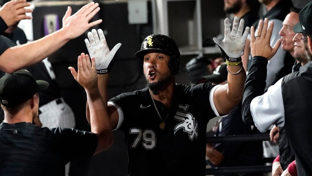 Chicago White Sox's Jose Abreu is congratulated in the dugout after his home run during the eighth inning of the team's baseball game against the Colorado Rockies on Tuesday, Sept. 13, 2022, in Chicago. The White Sox won 4-2.