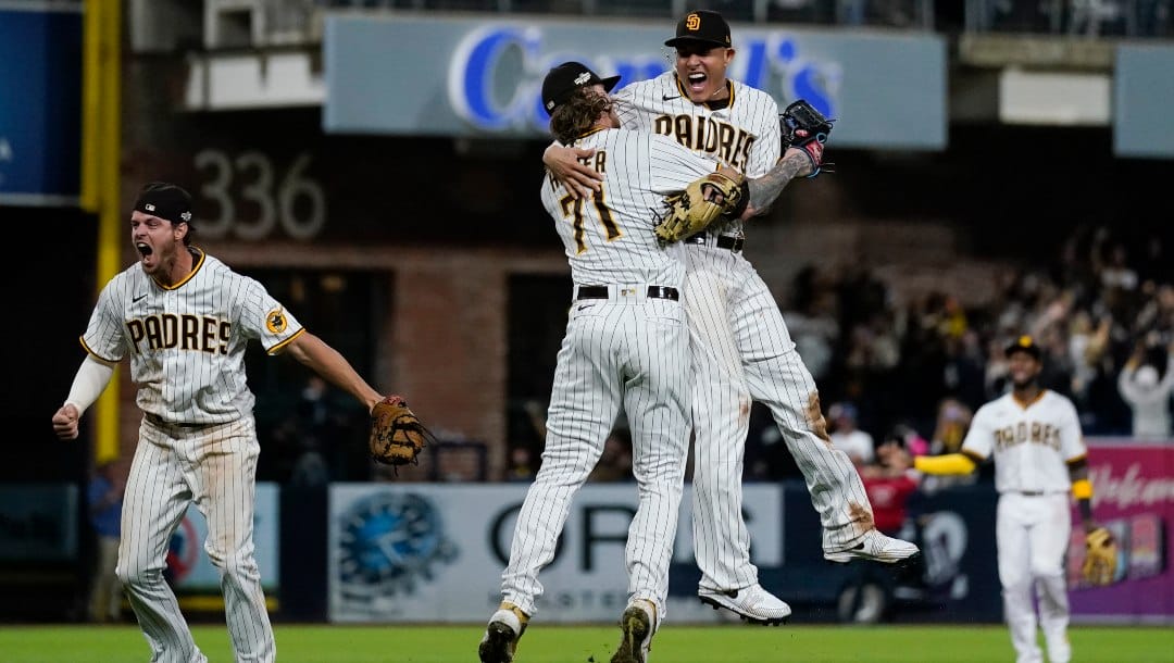 San Diego Padres third baseman Manny Machado, right, celebrates with relief pitcher Josh Hader (71) after the Padres defeated the Los Angeles Dodgers 5-3 in Game 4 of a baseball NL Division Series, Saturday, Oct. 15, 2022, in San Diego.