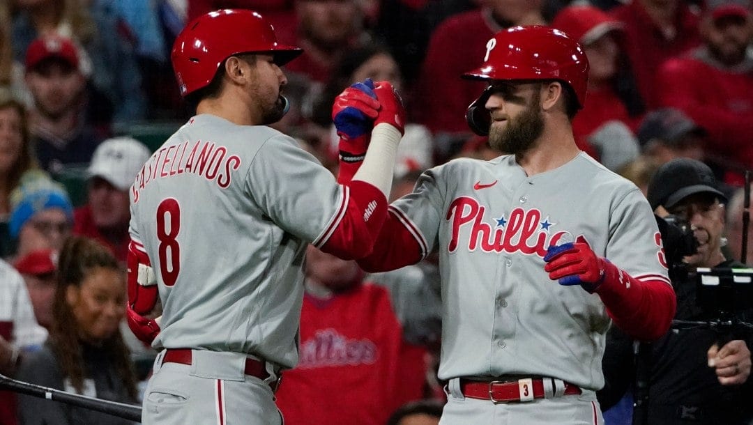 Philadelphia Phillies' Bryce Harper celebrates with Nick Castellanos (8) after Harper hit a solo home run against the St. Louis Cardinals during the second inning in Game 2 of an NL wild-card baseball playoff series, Saturday, Oct. 8, 2022, in St. Louis.