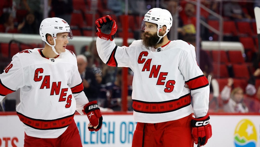 Carolina Hurricanes' Brent Burns (8) celebrates a goal with teammate Martin Necas (88) against the Columbus Blue Jackets during the second period of an NHL pre season hockey game in Raleigh, N.C., Monday, Oct. 3, 2022.