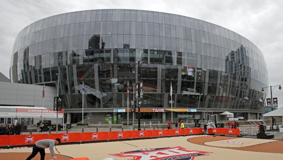 A worker dismantles a fan attraction for the Big 12 Conference men's NCAA college basketball tournament in front of the Sprint Center, Thursday, March 12, 2020, in Kansas City, Mo., after the remaining games in the tournament were canceled due to concerns about the coronavirus. (AP Photo/Charlie Riedel)