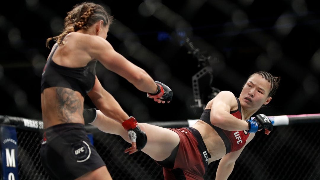 Weili Zhang kicks Tecia Torres in a women's strawweight mixed martial arts bout at UFC 235, Saturday, March 2, 2019.