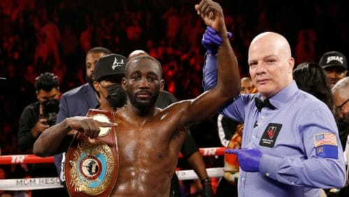 Terence Crawford poses for photographers after defeating Shawn Porter by TKO in a welterweight title boxing match, Nov. 20, 2021.