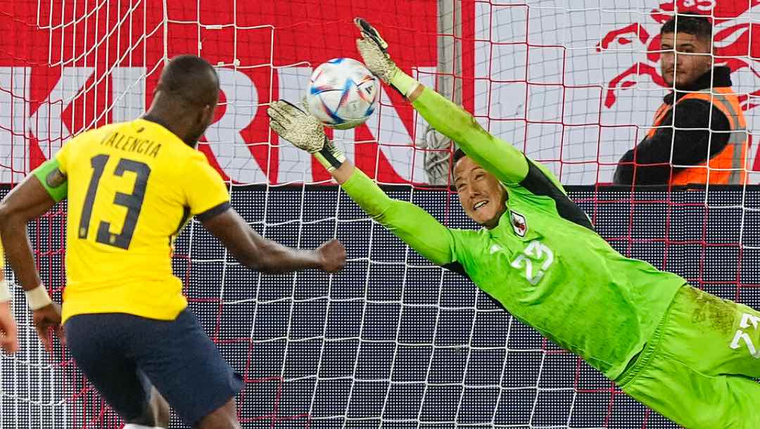 Japan's goalkeeper Daniel Schmidt saves a penalty shot by Ecuador's Enner Valencia.