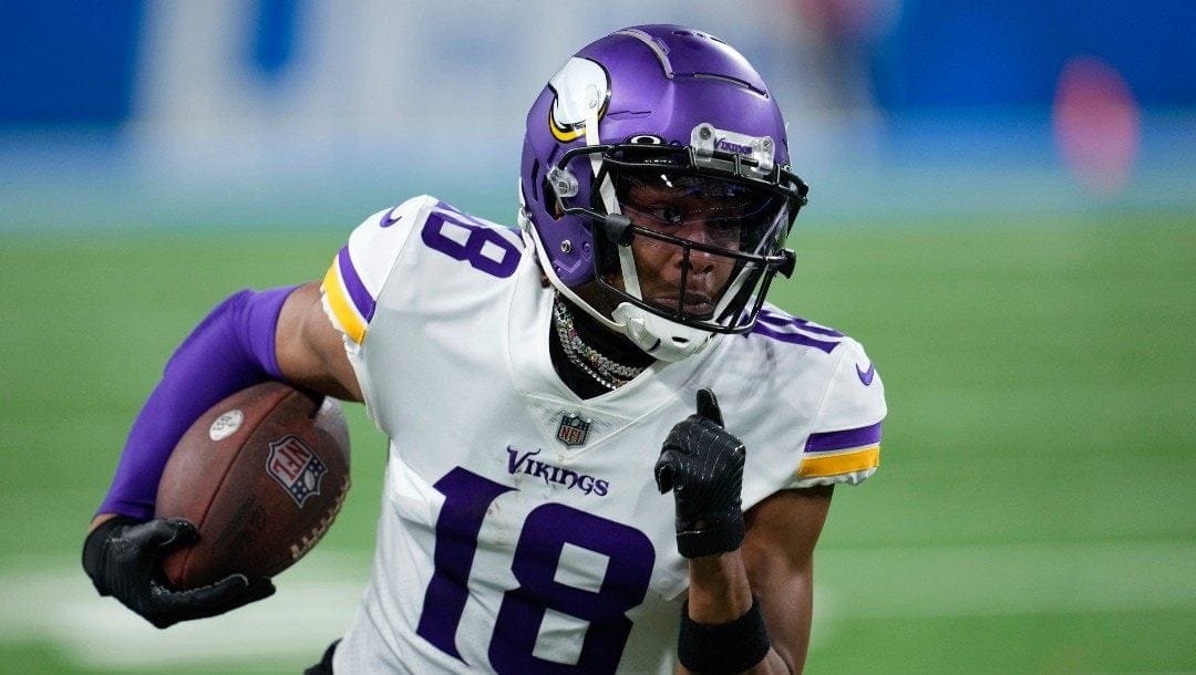Minnesota Vikings wide receiver Justin Jefferson (18) runs after a catch against the Detroit Lions during an NFL football game in Detroit, Sunday, Dec. 11, 2022.