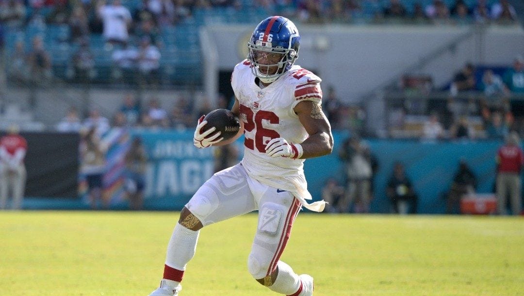 New York Giants running back Saquon Barkley (26) rushes for yardage during the second half of an NFL football game against the Jacksonville Jaguars, Sunday, Oct. 23, 2022, in Jacksonville, Fla.