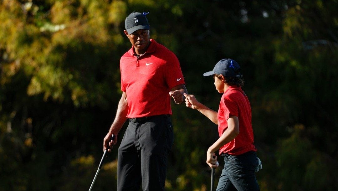 Tiger Woods fist bumps his son Charlie Woods on the 16th green during the second round of the PNC Championship golf tournament, Sunday, Dec. 19, 2021, in Orlando, Fla. Speculation for 2022 starts with where Woods will show up next on the PGA Tour.