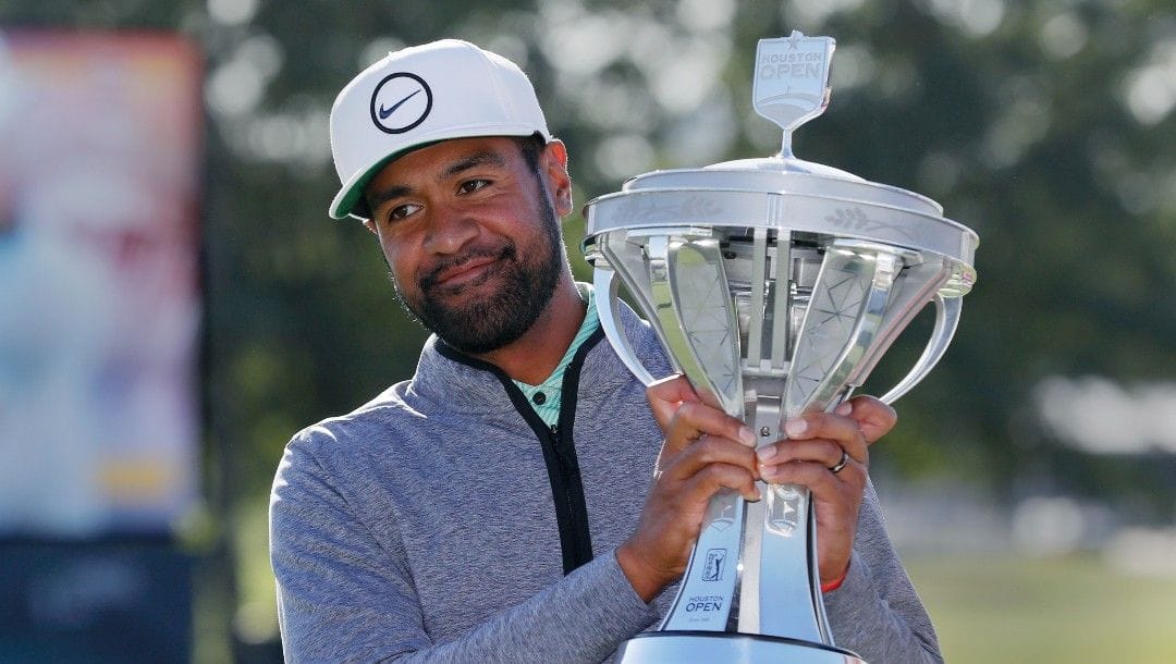 Tony Finau holds up the trophy at the end of the final round after winning the Houston Open golf tournament Sunday, Nov. 13, 2022, in Houston.