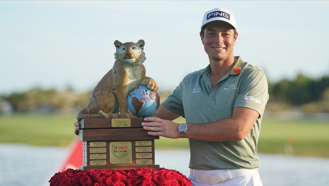 Viktor Hovland, of Norway, holds the championship trophy after the final round of the Hero World Challenge PGA Tour at the Albany Golf Club, in New Providence, Bahamas, Sunday, Dec. 5, 2021.
