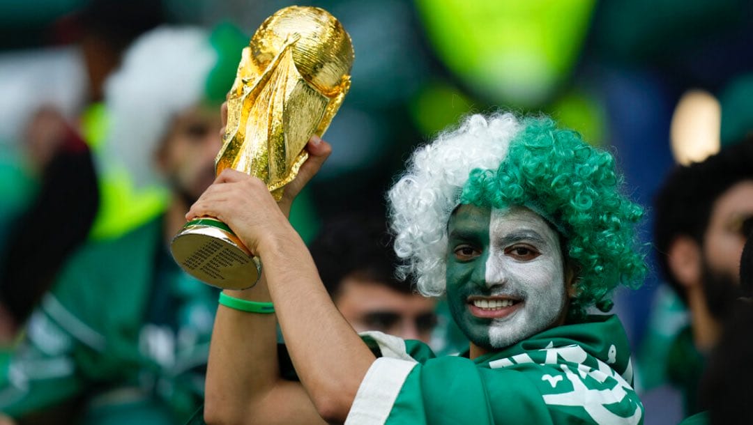 A Saudi Arabia fan holds up a copy of the World Cup trophy prior of the World Cup group C soccer match between Poland and Saudi Arabia, at the Education City Stadium in Al Rayyan , Qatar, Saturday, Nov. 26, 2022.