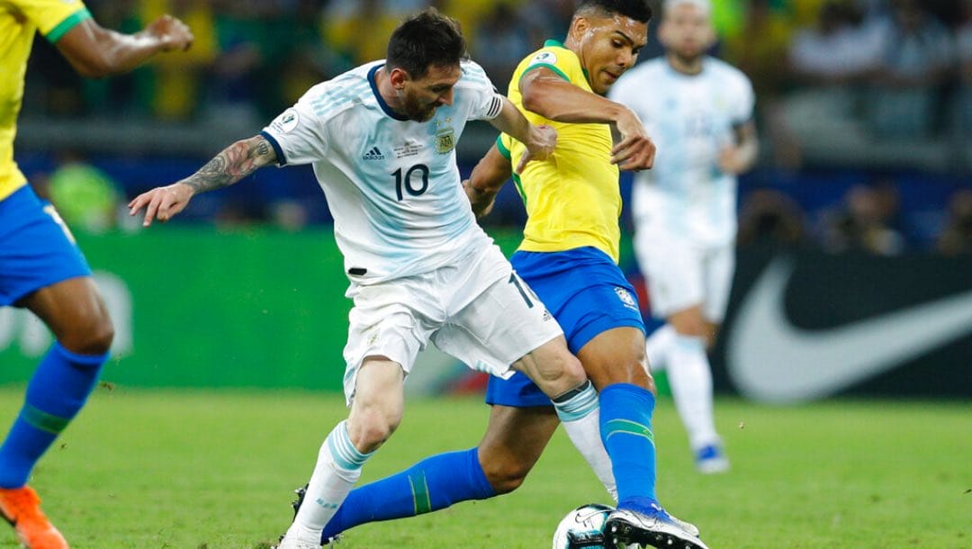 Argentina's Lionel Messi, left, vies for the ball with Brazil's Casemiro during a Copa America semifinal soccer match.
