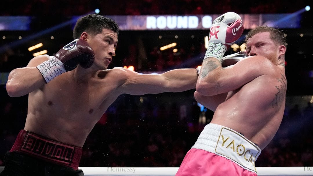Dmitry Bivol, of Kyrgyzstan, hits Canelo Alvarez, of Mexico, during a light heavyweight title fight, Saturday, May 7, 2022.