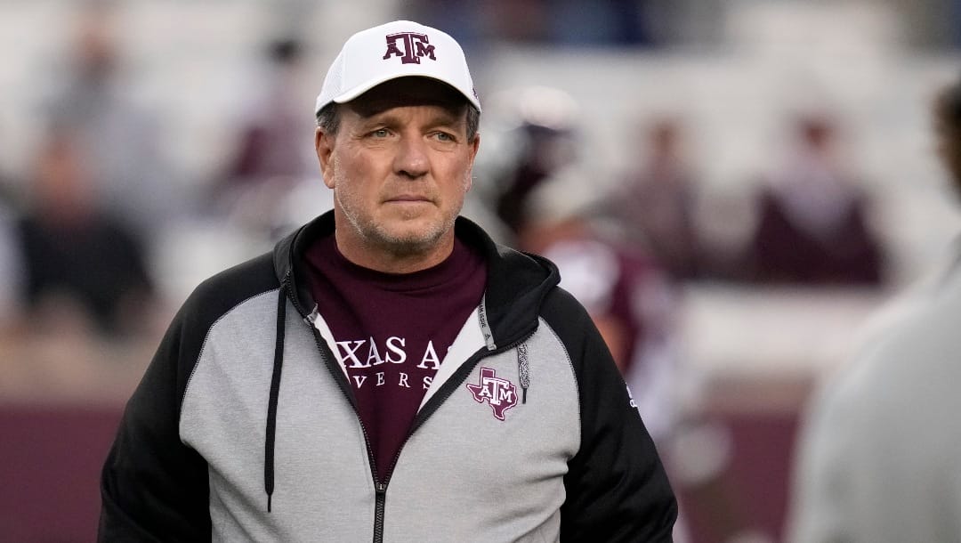 Texas A&M head coach Jimbo Fisher watches his team during warmups before the starts of an NCAA college football game against Mississippi Saturday, Oct. 29, 2022, in College Station, Texas. (AP Photo/Sam Craft)