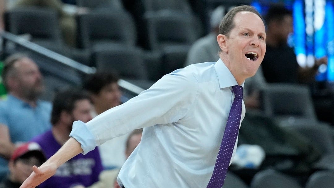 Washington head coach Mike Hopkins reacts during the first half of an NCAA college basketball game against Utah in the first round of the Pac-12 tournament Wednesday, March 9, 2022, in Las Vegas. (AP Photo/John Locher)