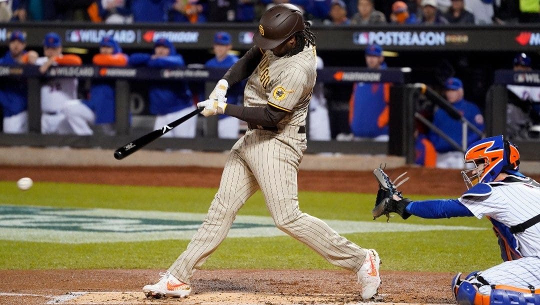 San Diego Padres first baseman Josh Bell connects for a single against the New York Mets during the second inning of Game 3 of a National League wild-card baseball playoff series, Sunday, Oct. 9, 2022, in New York.