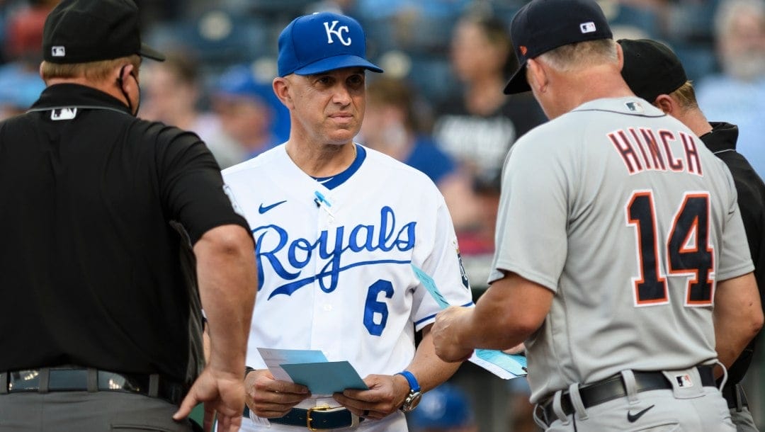 Kansas City Royals bench coach Pedro Grifol meets with Detroit Tigers manager A.J. Hinch and the umpires before the start of their baseball game in Kansas City, Mo., Monday, June 14, 2021.
