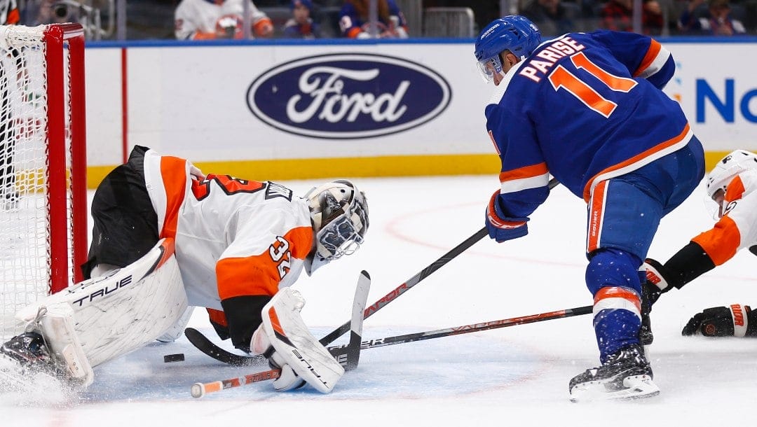 New York Islanders left wing Zach Parise (11) pokes the puck between the pads of Philadelphia Flyers goalie Felix Sandstrom for a goal during the second period of an NHL hockey game Saturday, Nov. 26, 2022, in Elmont, N.Y.