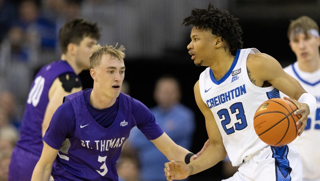 St. Thomas' Andrew Rohde (3) defends against Creighton's Trey Alexander (23) during the second half of an NCAA college basketball game on Monday, Nov. 7, 2022, in Omaha, Neb. Creighton defeated St. Thomas 72-60. (AP Photo/Rebecca S. Gratz)