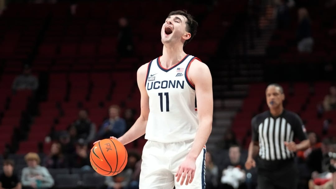 Connecticut forward Alex Karaban (11) celebrates after winning the championship against Iowa State in the Phil Knight invitational Sunday, Nov. 27, 2022, in Portland, Ore. (AP Photo/Rick Bowmer)