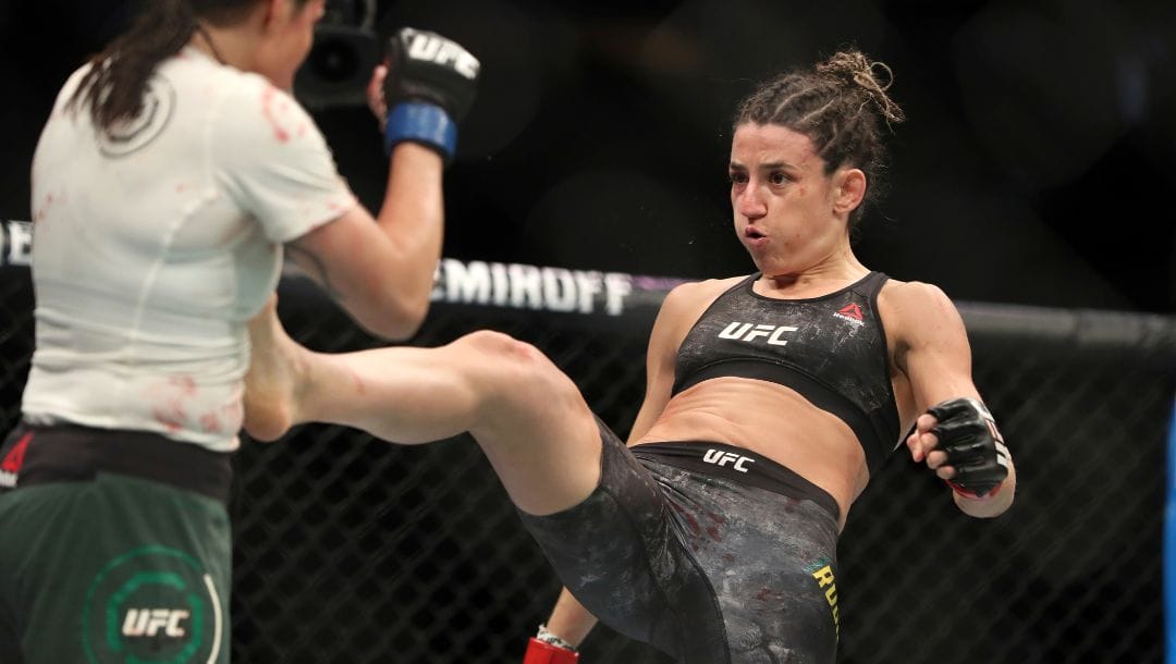 Marina Rodriguez, right, lands a kick against Jessica Aguilar during their mixed martial arts bout at UFC Fight Night.