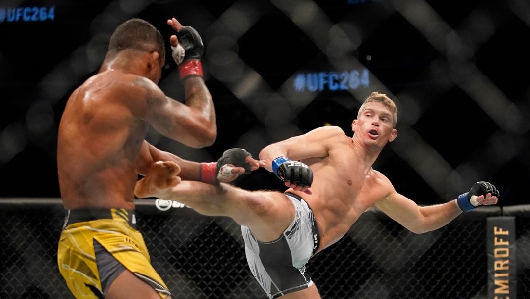 Stephen Thompson, right, kicks Gilbert Burns in a UFC 264 welterweight mixed martial arts bout Saturday, July 10, 2021.