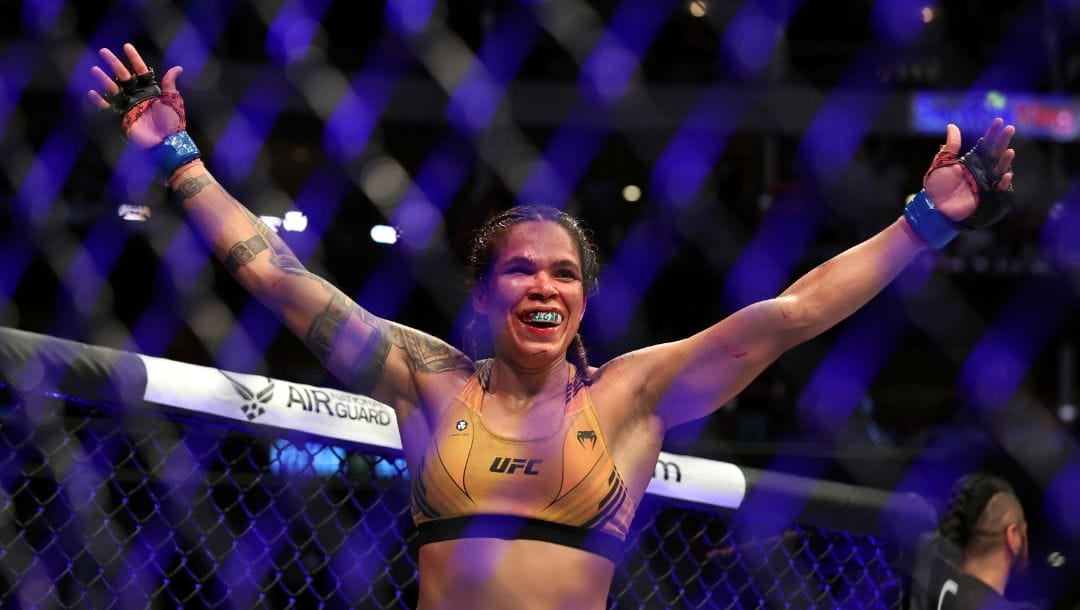 Amanda Nunes celebrates after defeating Julianna Pena in a bout for the mixed martial arts bantamweight title.