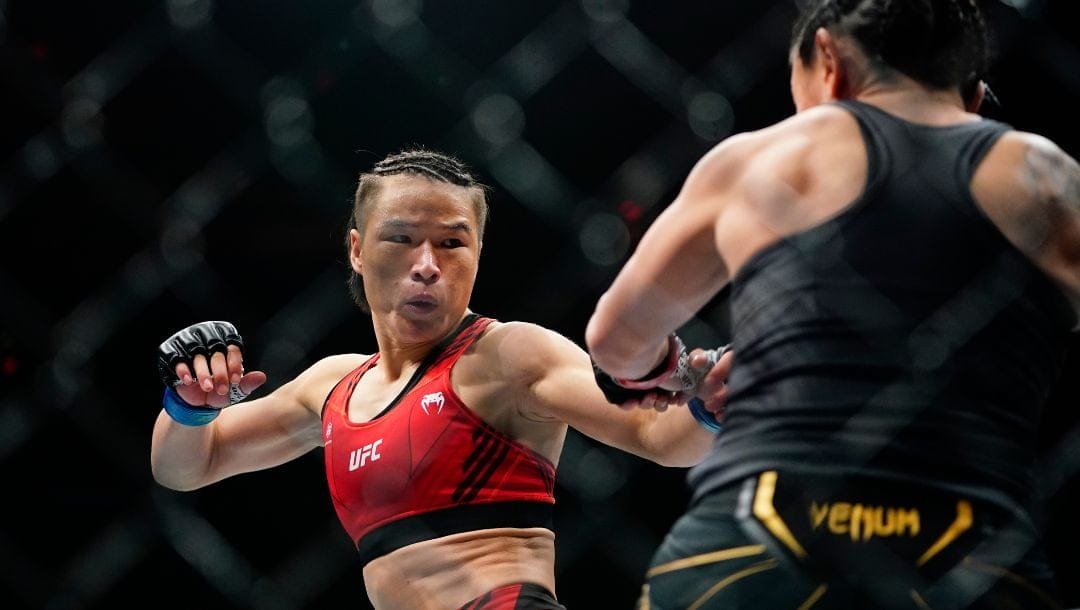 China's Zhang Weili, left, fights Carla Esparza during the first round of a women's strawweight title bout in the UFC 281.