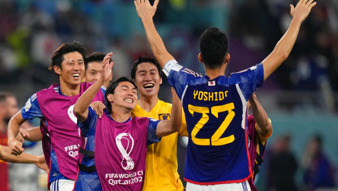 Japan players celebrate after their win in the World Cup group E soccer match between Japan and Spain, at the Khalifa International Stadium in Doha, Qatar, Thursday, Dec. 1, 2022.